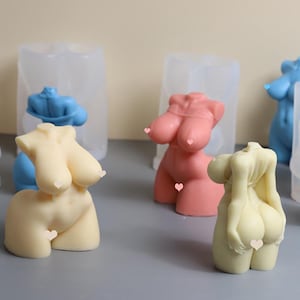 May include: Four silicone molds for making candles in the shape of a human torso. The molds are clear and show the details of the candle shapes. The candles are in various colors, including pink, blue, and beige.