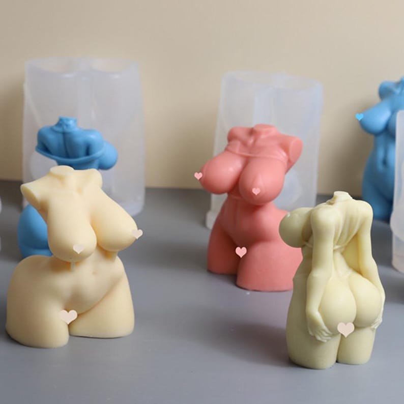 May include: Four silicone molds for making candles in the shape of a human torso. The molds are clear and show the details of the candle shapes. The candles are in various colors, including pink, blue, and beige.