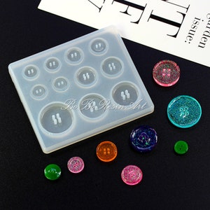 May include: A clear silicone mold with 10 round button shapes. The mold is on a black surface with several colorful resin buttons.
