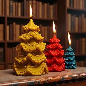 May include: Three lit Christmas tree-shaped candles in yellow, red, and teal. The yellow candle has a beaded design, while the red and teal candles have a simpler, textured appearance. The candles are on a wooden surface with a blurred bookshelf background.