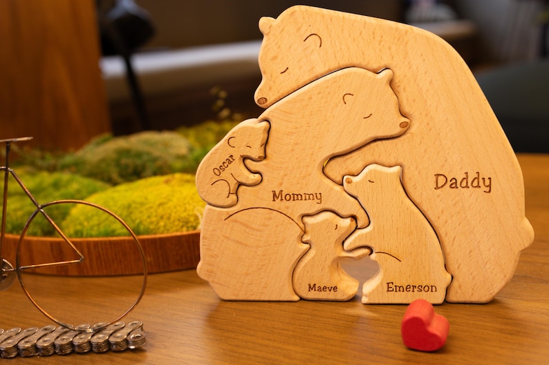 May include: Wooden bear family puzzle with the names "Daddy", "Mommy", "Emerson", "Maeve", and "Oscar" engraved on each bear.