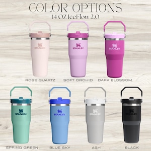 May include: A collection of eight 14 oz Stanley IceFlow 2.0 tumblers in various colors, including Rose Quartz, Soft Orchid, Dark Blossom, Spring Green, Blue Sky, Ash, and Black. Each tumbler has a handle and the Stanley logo.