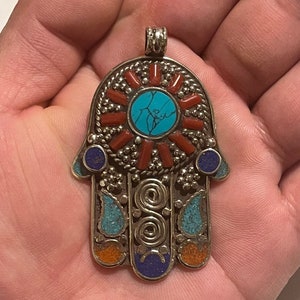 Beautiful handmade Himalayan white metal hand pandant with inlaid stones from Nepal.