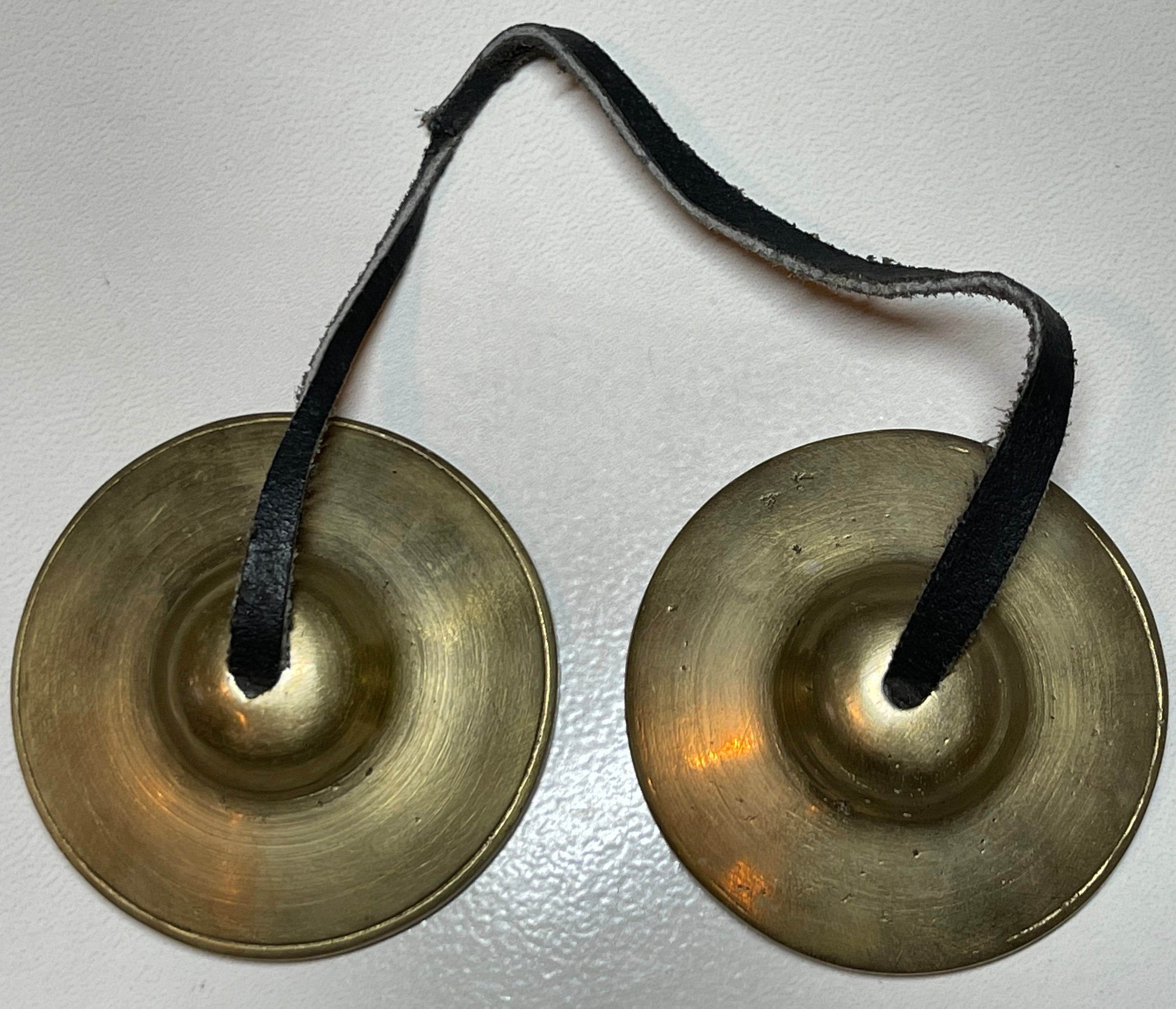 Tiny cymbals on a string deals