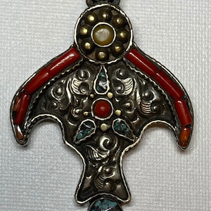 Beautiful /interesting shape of old handmade from white brass pandant with inlaid stones coral,torquise & amber from Tibet.