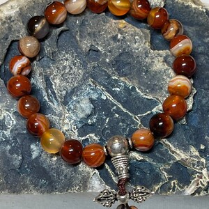 Beautiful Spiritual 8mm Smooth Rounded Red-Striped Agate Beaded Good Luck Bracelet with a Dorje Tassle from the Himalayas