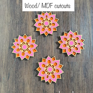 May include: Four decorative wooden cutouts in a floral design. Each cutout features a pink flower with orange and gold accents. The text "Wood/ MDF cutouts" is at the top, and "CutsByShruthi" is at the bottom.