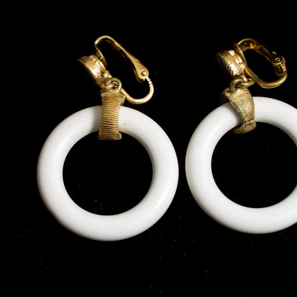 Sigmed Crown Trifari Hoop Earrings. White Plastic with Gold tone Clip on fitting.