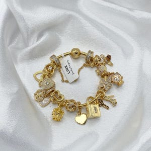 Linx Yellow Gold Snake Chain Bracelet with Gold and Cubic Zirconia Themed Charms