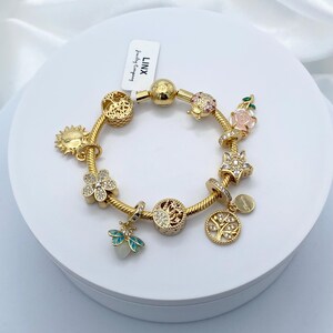 Linx Yellow Gold Snake Chain Bracelet with Green and Gold Charms