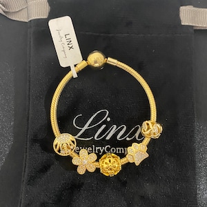 Linx Yellow Gold Snake Chain Bracelet with Gold and Cubic Zirconia Themed Charms