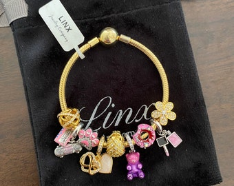 Linx Yellow Gold Snake Chain Bracelet with Gold Purple and Pink Themed Charms