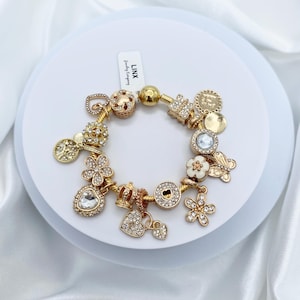 Linx Yellow Gold Snake Chain Bracelet with Gold Charms