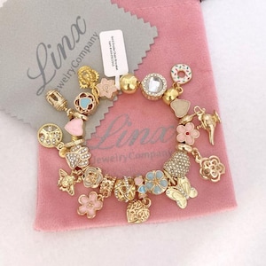 Linx Yellow Gold Snake Chain Bracelet with Gold  Pink and Blue Themed Charms