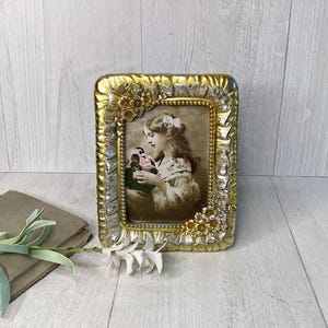 May include: A set of three ceramic mugs with a speckled, matte finish. The mugs are in shades of cream, light gray, and dark gray. Each mug has a simple, minimalist design and a rounded handle.