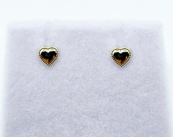 May include: A pair of gold heart-shaped stud earrings with a textured edge.