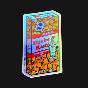 May include: A holographic sticker featuring a cartoon character with a mustache and a red and yellow box of caramel coated popcorn and peanuts. The box says "Stache & Bash" and "The Original". The sticker is 1.02 oz (29.3g).