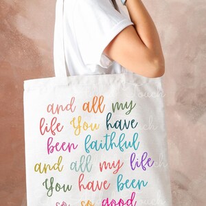 May include: A white canvas tote bag with the text "and all my life you have been faithful and all my life you have been so, so good" printed in rainbow colors.
