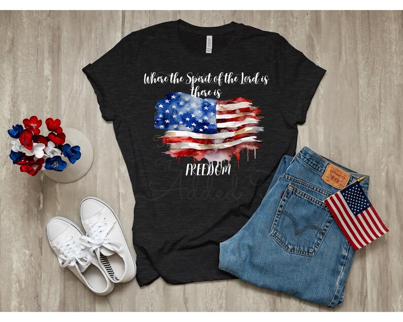 May include: A black t-shirt with a watercolor American flag design and the text "Where the Spirit of the Lord is there is FREEDOM".