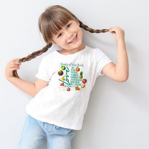 May include: A white t-shirt with a graphic of fruit and the text "Fruits of the Spirit" and "Love" with the words "Joy, Peace, Patience, Kindness, Goodness, Faithfulness, Gentleness, Self Control" listed vertically. The text "Galatians 5:22-23" is at the bottom of the graphic.