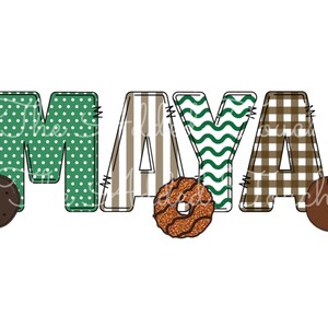 May include: The name "MAYA" is spelled out in colorful fabric letters. Each letter has a different pattern: polka dots, stripes, wavy lines, and plaid. There are two chocolate chip cookies on either side of the name.