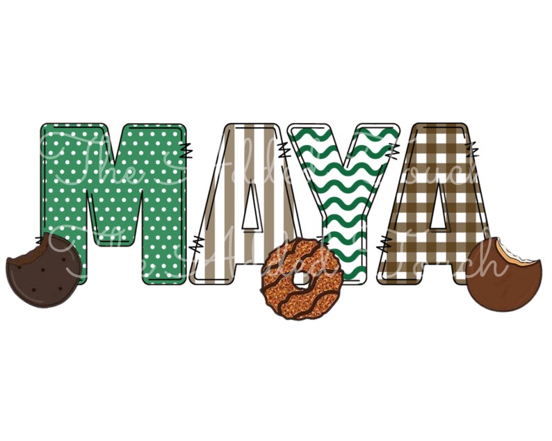 May include: The name "MAYA" is spelled out in colorful fabric letters. Each letter has a different pattern: polka dots, stripes, wavy lines, and plaid. There are two chocolate chip cookies on either side of the name.