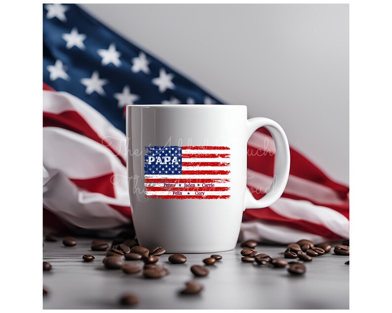 May include: White ceramic mug with a distressed American flag design. The flag is red, white, and blue with the word "PAPA" in blue at the top. Below the flag are the names "Finn, Jaden, Carlie, Felix, Cory" in blue.