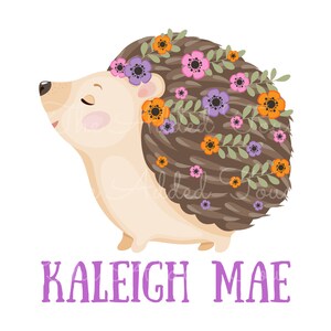 May include: A whimsical illustration of a hedgehog with a floral crown. The hedgehog has brown quills, a cream-colored body, and is adorned with a wreath of orange, purple, and pink flowers. The name "KALEIGH MAE" is written in purple below the hedgehog.