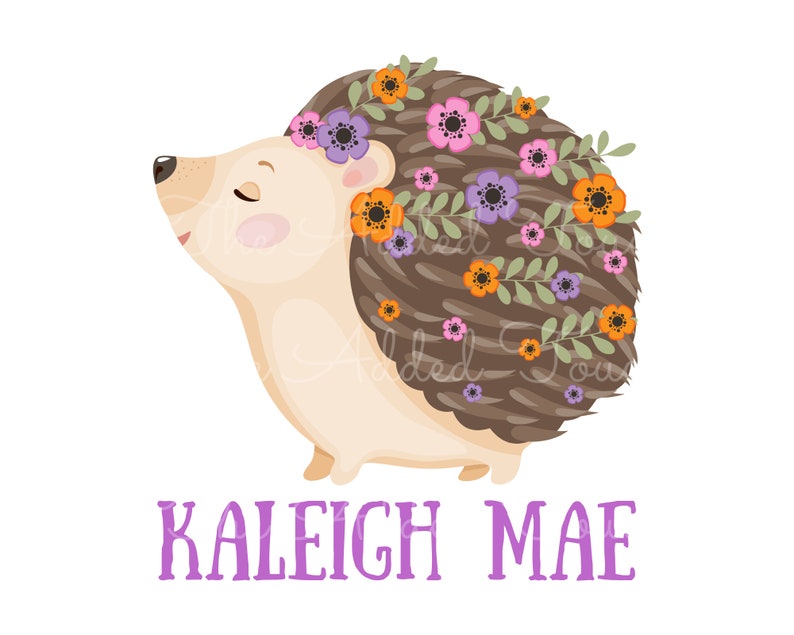 May include: A whimsical illustration of a hedgehog with a floral crown. The hedgehog has brown quills, a cream-colored body, and is adorned with a wreath of orange, purple, and pink flowers. The name "KALEIGH MAE" is written in purple below the hedgehog.