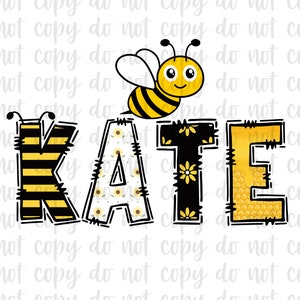 May include: A yellow and black bee with a smiling face is flying above the name "KATE" in black letters with yellow and white accents. The letters are decorated with a honeycomb pattern, sunflowers, and stripes.