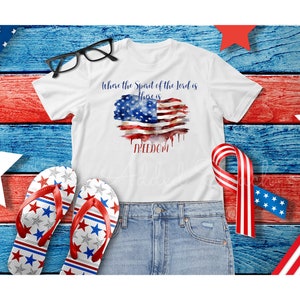 May include: White t-shirt with a watercolor American flag design and the text "Where the Spirit of the Lord is there is FREEDOM".