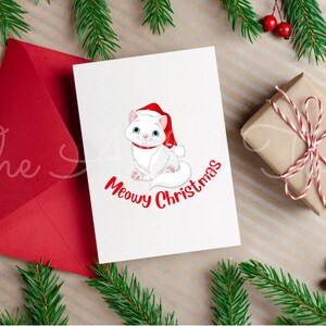 May include: A Christmas card with a white cat wearing a Santa hat and the words "Meowy Christmas" in red. A red envelope, a wrapped gift, and evergreen branches with red berries complete the festive scene.