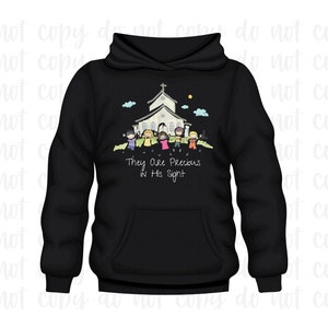 May include: Black hoodie with a white church and children holding hands in front of it. The text "They are Precious in His Sight" is printed below the image.