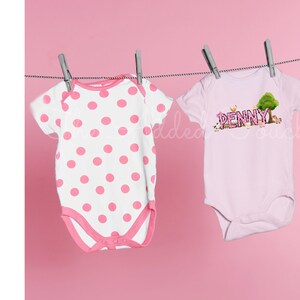 May include: Two pink baby onesies hanging on a clothesline. One onesie has white polka dots and the other has the name "PENNY" with farm animals and a tree.
