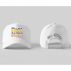 May include: White baseball cap with the text "First Grade" in yellow and pink on the front and "Mrs. Jeffries" on the back.