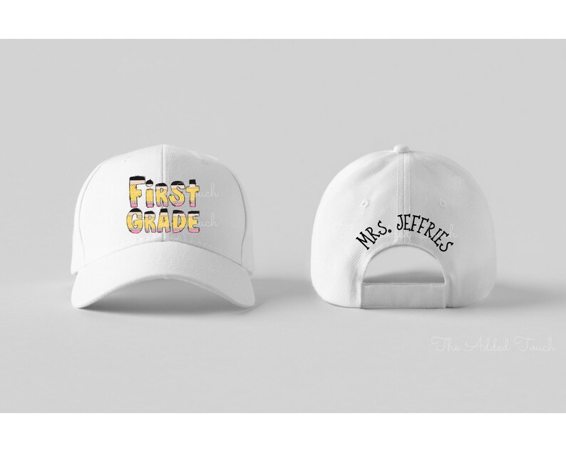 May include: White baseball cap with the text "First Grade" in yellow and pink on the front and "Mrs. Jeffries" on the back.