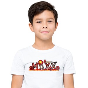 May include: A white t-shirt with the name "MAXX" spelled out in red letters with a firefighter theme. The letters are decorated with images of fire hoses, axes, and fire helmets.