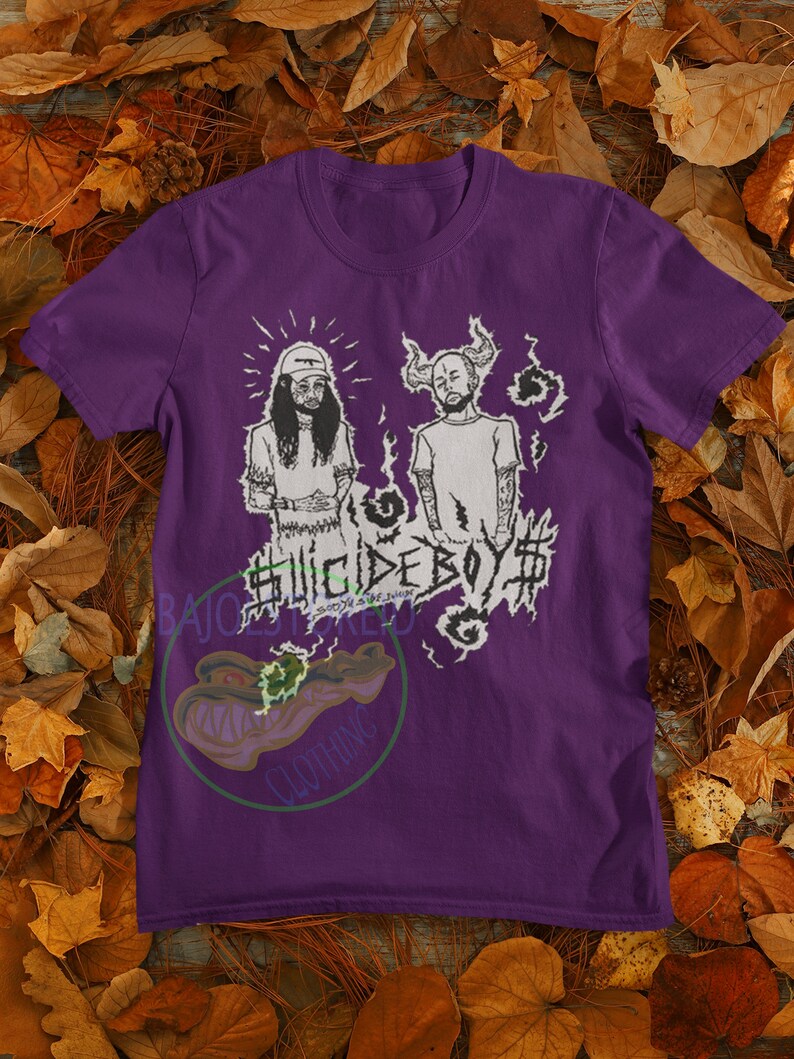 May include: Purple t-shirt with a black and white graphic of two men with the text "Suicideboy$  " printed on the front.
