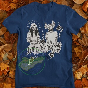 May include: A navy blue t-shirt with a white graphic print of two figures with the text "#SUICIDEBOY$#" in a stylized font.