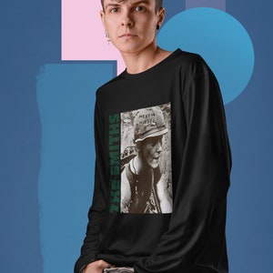 May include: Black long-sleeve shirt with a graphic print of a person wearing a military helmet with the text "Meat is Murder" on it. The text "The Smiths" is printed vertically on the left side of the graphic.