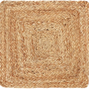 May include: Square jute rug with a woven design. The rug features a concentric square pattern, with a central spiral detail. The natural tan color and textured surface create a rustic, earthy aesthetic. Ideal for adding warmth and texture to any space.