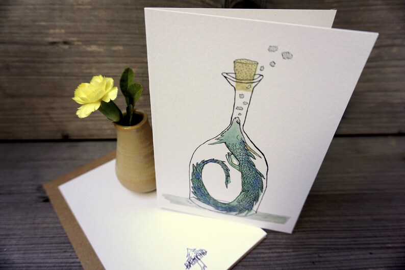 May include: A green and blue dragon is trapped inside a clear glass bottle with a cork stopper. The dragon is curled up in the bottle and has its head sticking out of the top. There are small white bubbles coming out of the bottle.