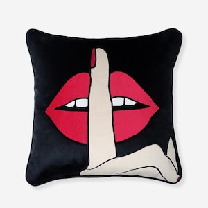 May include: Black velvet cushion featuring an embroidered red mouth with a finger over it, signifying silence.