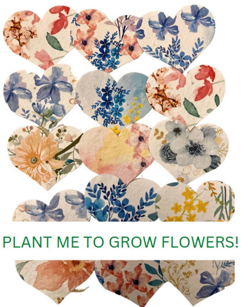 May include: A collection of 14 heart-shaped seed paper cards with floral designs. The cards are printed with the text "PLANT ME TO GROW FLOWERS!"