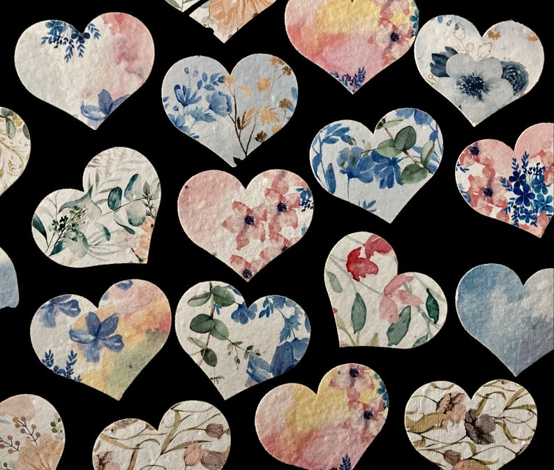 May include: Assortment of heart-shaped paper confetti with floral and watercolour designs in shades of blue, pink, and green.