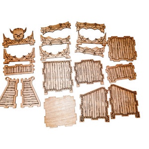 May include: A set of laser-cut wooden pieces for building a spooky box. The pieces are in various shapes and sizes, with some featuring a skull and spiderweb design.