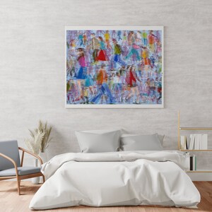 May include: A framed abstract painting of a crowd of people in various colors and patterns. The painting is hanging on a light gray wall above a white bed with gray pillows.