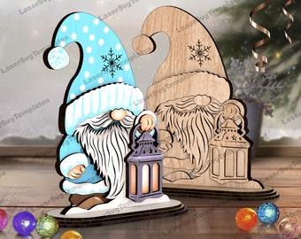 May include: Two wooden gnome ornaments with a blue and white gnome holding a lantern and a brown gnome holding a lantern. The gnomes are standing on a wooden base.
