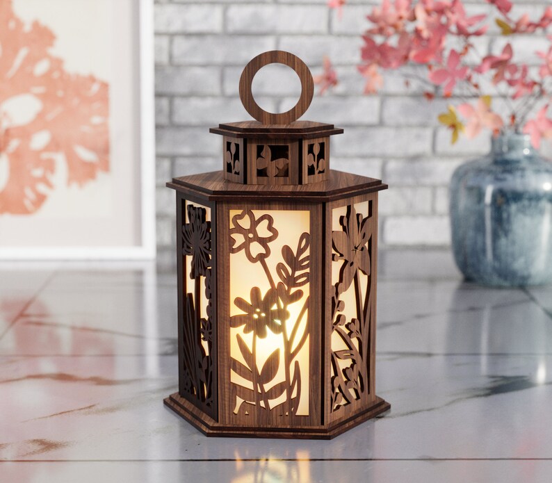 May include: A wooden lantern with a hexagonal shape and intricate floral cutouts. The lantern has a frosted glass panel and a warm glow emanating from inside.