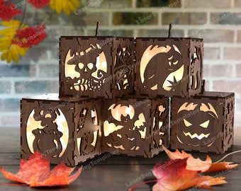 May include: Set of six wooden Halloween lantern boxes with different spooky designs, including a skull, a cat, a bat, a ghost, a pumpkin, and a spider web. The lanterns are illuminated from within, casting a warm glow.